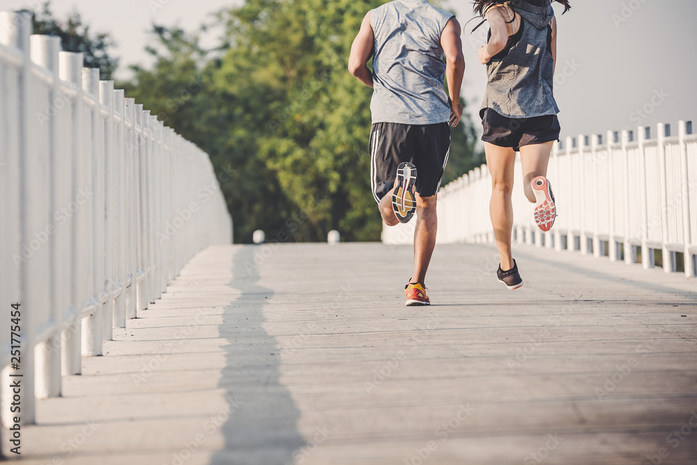 custom made wallpaper toronto digitalyoung couple runner running on running road in city park