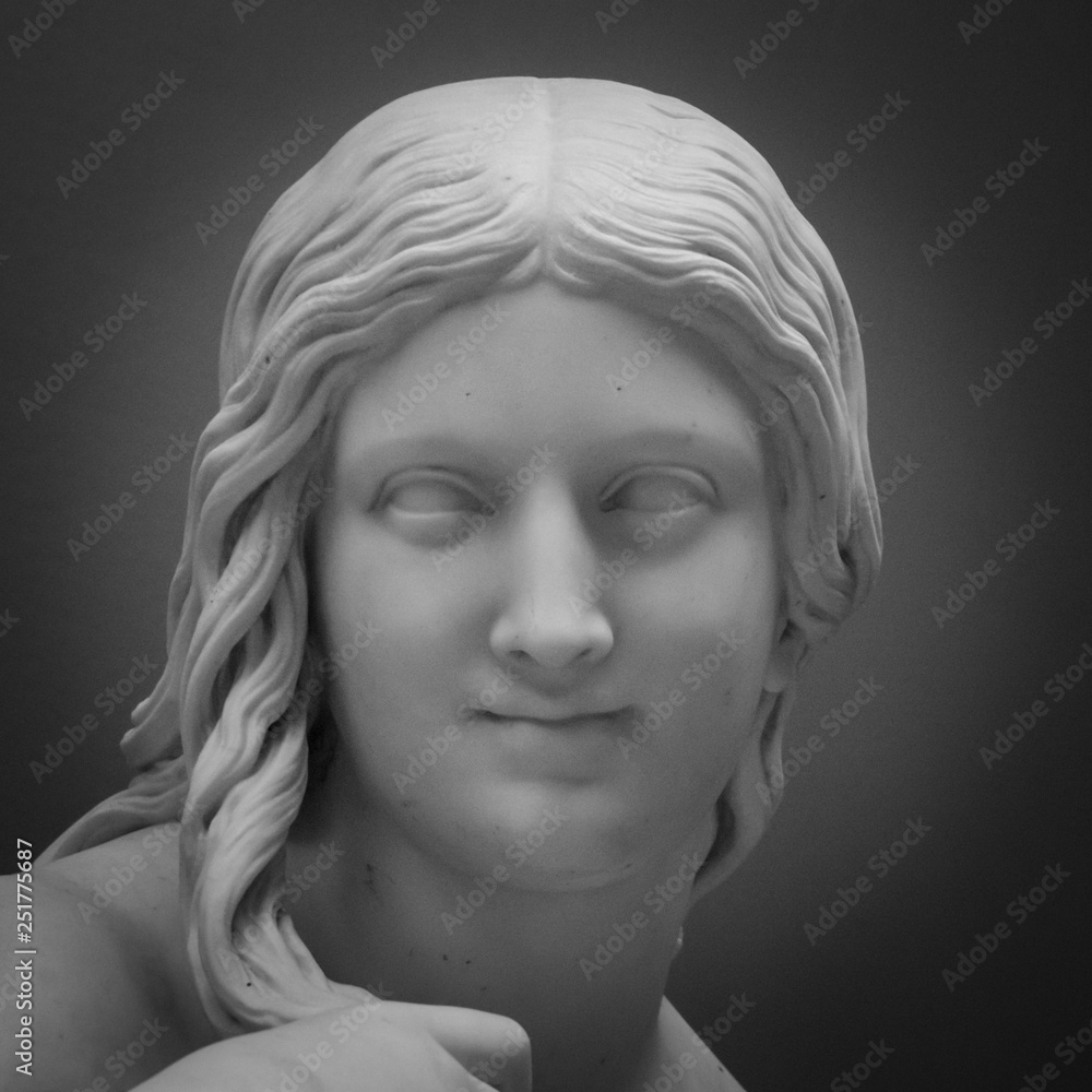White marble head of young woman. Statue of a woman in the antique style. Ancient sculpture of lady face White marble head of young woman. Statue of a woman in the antique style. Ancient sculpture of lady face
