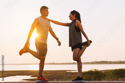 young couple doing exercises and warm up before run and Physical fitness test