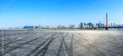 Empty asphalt square ground and city skyline with buildings in Hangzhou