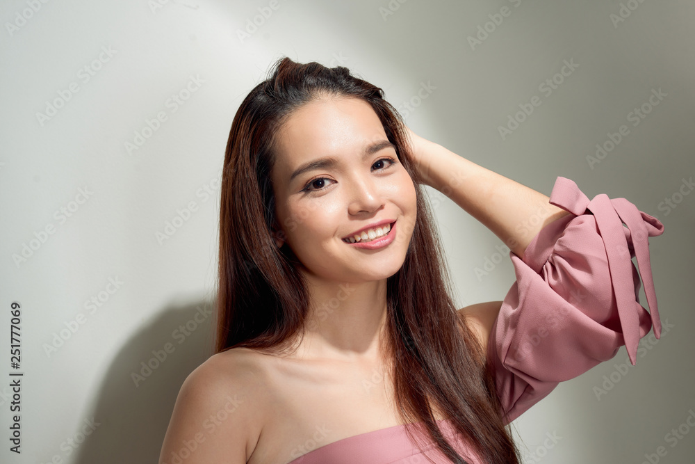 Spectacular asian young woman playing with her hair. Indoor photo of wonderful female model isolated on white background Spectacular asian young woman playing with her hair. Indoor photo of wonderful female model isolated on white background