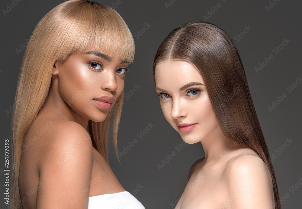Two wemen with dark and light skin tone caucasian and african american ...