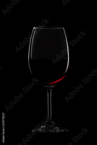 Glass of red wine on black background. Concept studio shot.