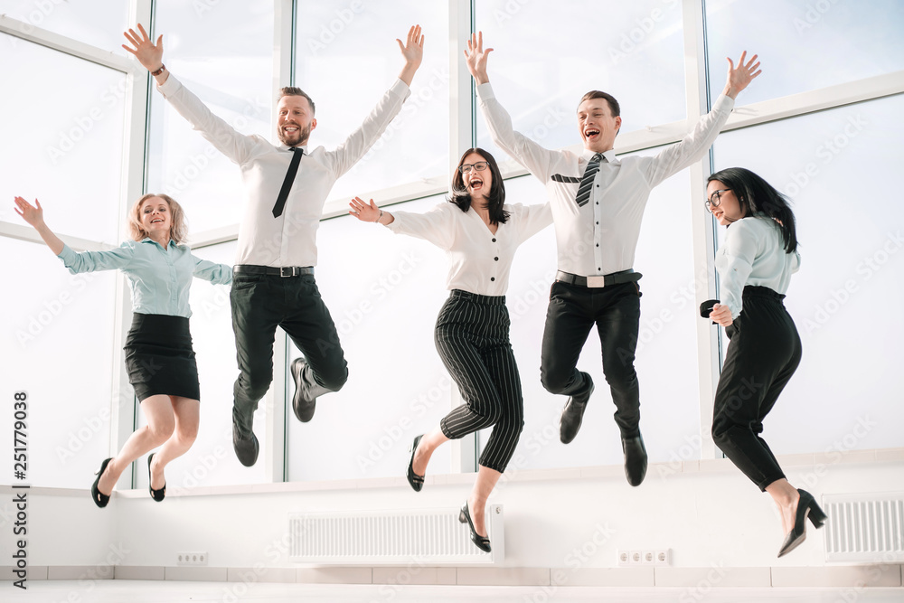 very happy business team rejoices in the spacious office