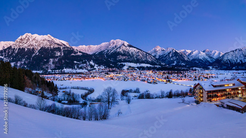 The valley Kleinwalsertal and Oberstdorf, Germany, with Alps in the winter with snow covered landscape in the evening.