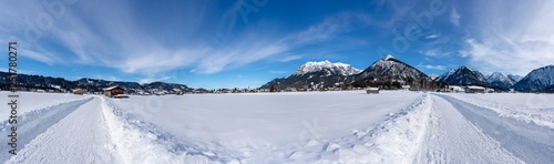 Sunny snow covered landscape near Oberstdorf  Bavaria  Germany. Panorama with hiking trail.