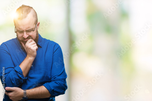 Young caucasian hipster man wearing glasses over isolated background thinking looking tired and bored with depression problems with crossed arms.