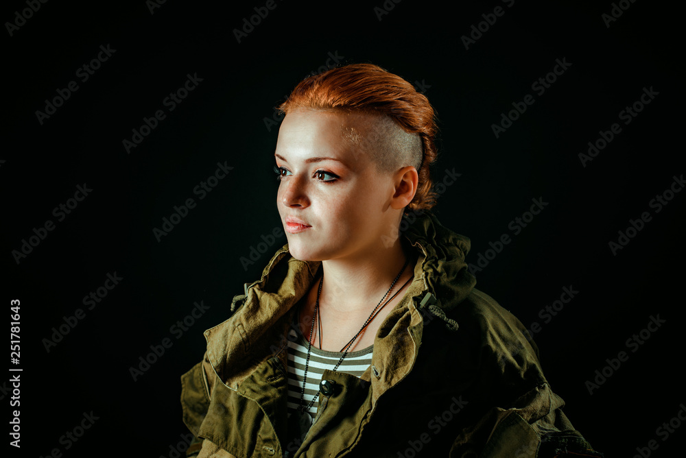Young woman with red hair in military uniform. Horizontal photo