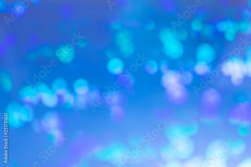 Bright blue abstract background. Spots, lights in blur.