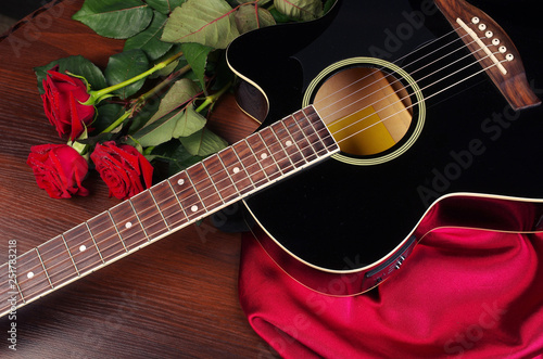 Acoustic guitar and a bouquet of roses