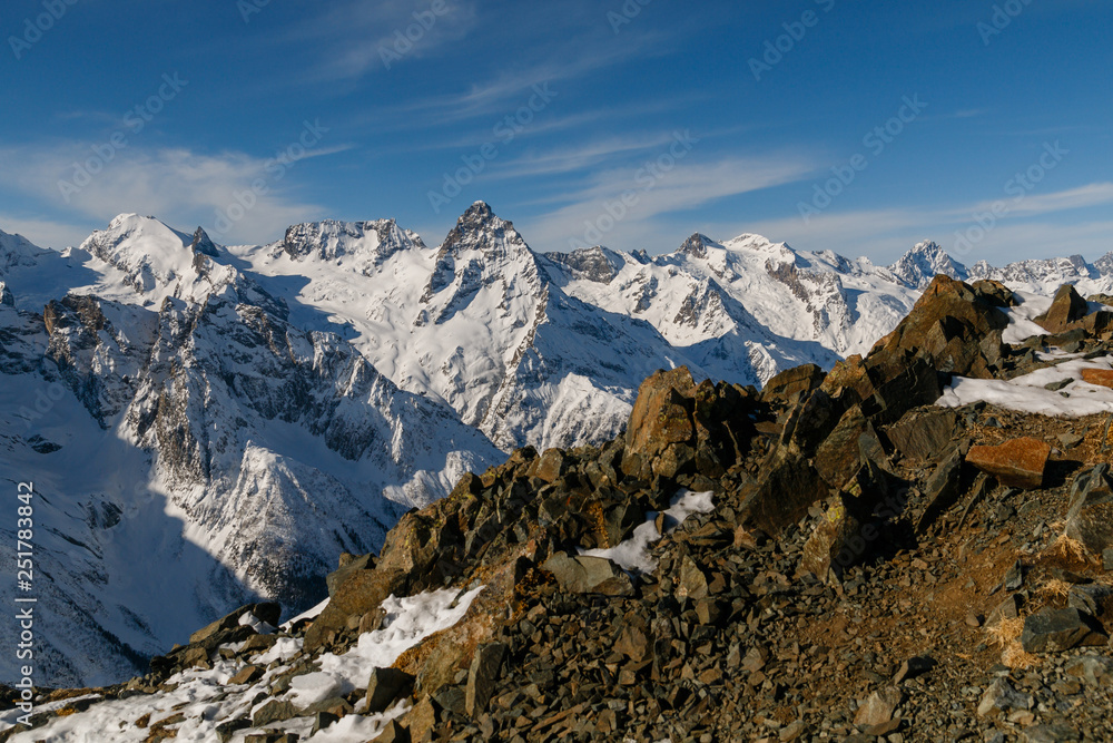 Snowy mountains. Stones and rocks. Mountain background. Small and big.