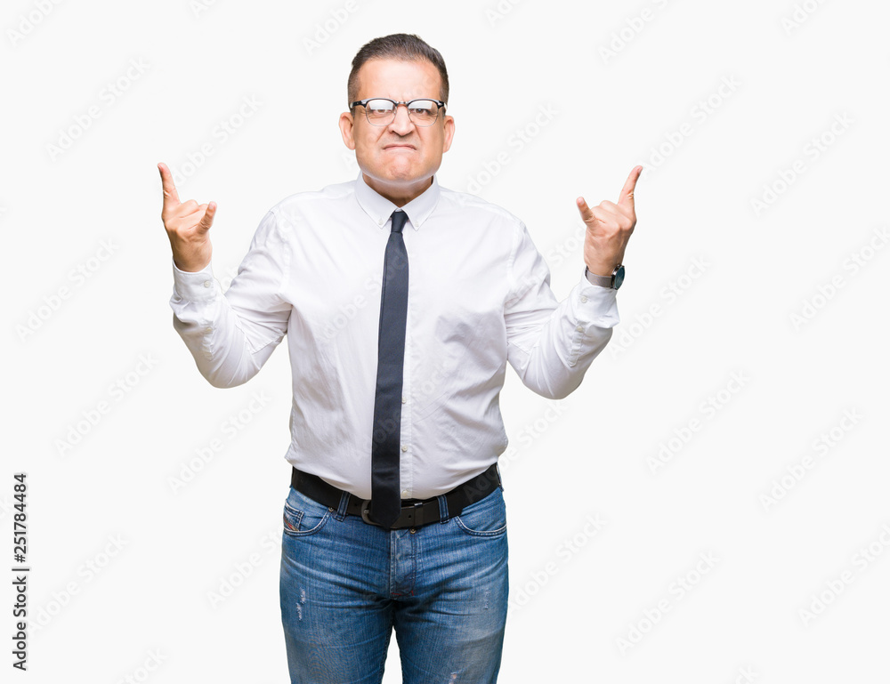 Middle age bussines arab man wearing glasses over isolated background shouting with crazy expression doing rock symbol with hands up. Music star. Heavy concept. Middle age bussines arab man wearing glasses over isolated background shouting with crazy expression doing rock symbol with hands up. Music star. Heavy concept.