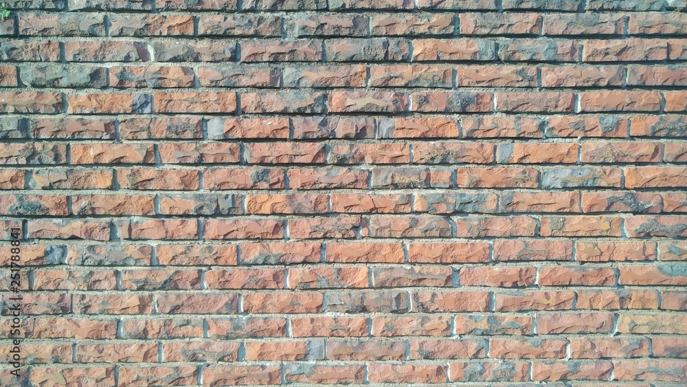 Naklejka premium Weathered stained old brick wall background