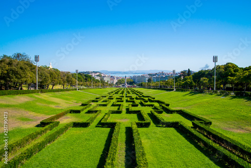 Obraz na płótnie View of the labyrinth of Eduardo VII park and gardens, the largest park in the center of Lisbon and Tagus river in the background, in Lisbon, Portugal w salonie