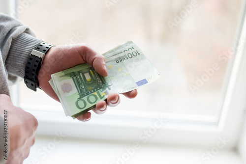 Man's hands with euro on white background. Financial business concept.
