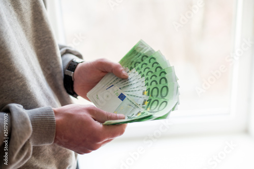 Man's hands with euro on white background. Financial business concept. photo