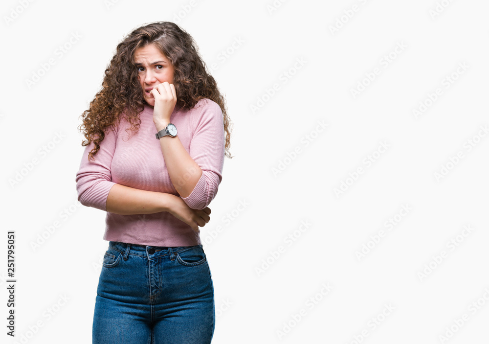 Beautiful brunette curly hair young girl wearing pink sweater over isolated background looking stressed and nervous with hands on mouth biting nails. Anxiety problem. Beautiful brunette curly hair young girl wearing pink sweater over isolated background looking stressed and nervous with hands on mouth biting nails. Anxiety problem.