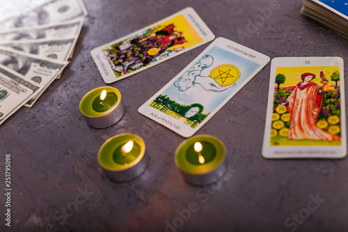 divination cards alignment for wealth and prosperity with money banknotes dollars and candles