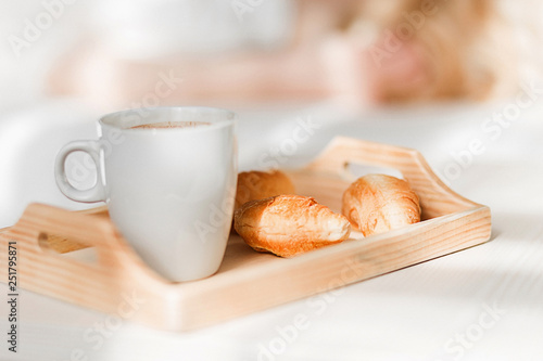 Breakfast with cup of black coffee and croissants