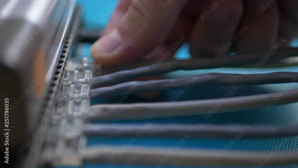 Man plugs ethernet cable into router Man plugs ethernet cable into router
