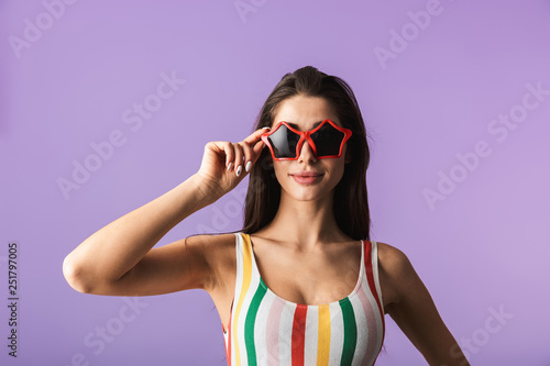 Cheerful young girl wearing swimsuit standing