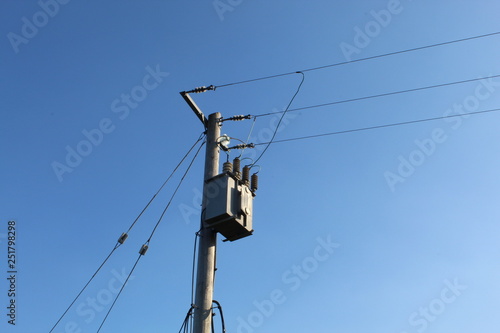 Low Angle View Of Electricity Pylon Against Clear Blue Sky