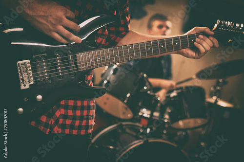 Obraz na płótnie Close up of unrecognizable guitarist playing black modern electric guitar