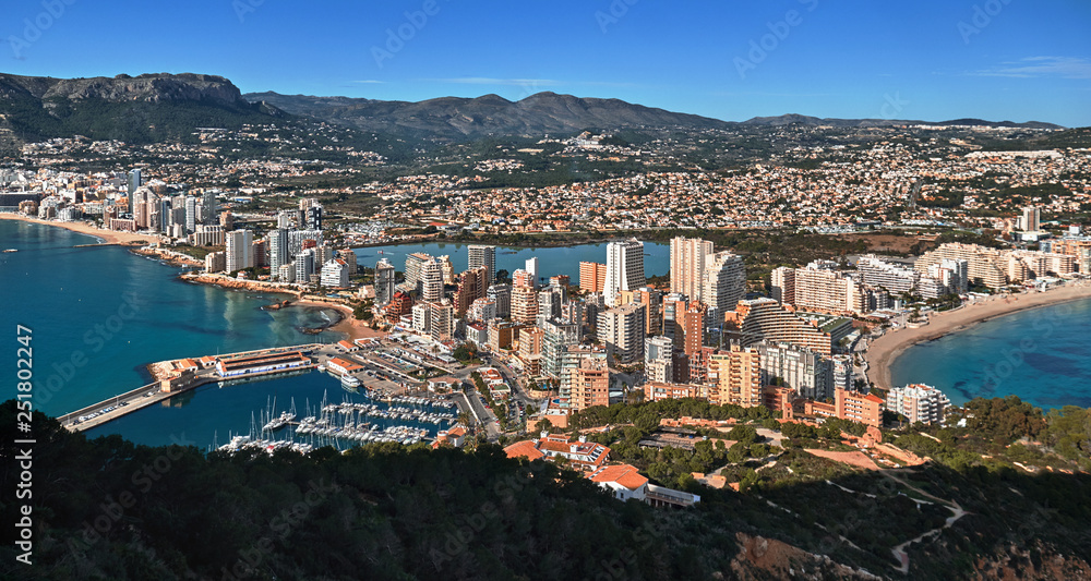 Aerial drone view picturesque photo from above Calpe cityscape salt lake, bay of Mediterranean Sea the both sides photo taken from Ifach rock. Province of Alicante, Costa Blanca, Spain