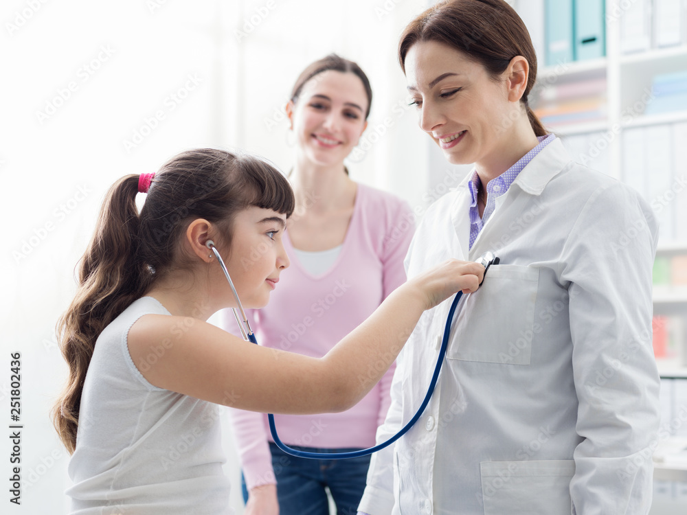 Friendly doctor playing with a young patient during a visit