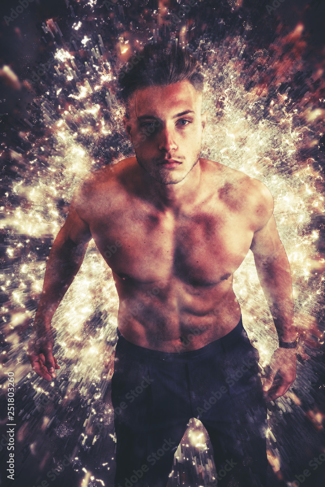 Confident shirtless man looking at camera in illusive effect of vibrant golden sparkles 
