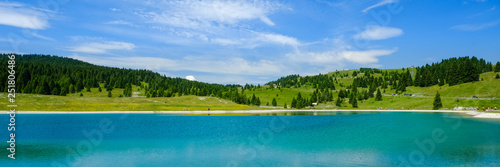 Panorama, landscape of a turquoise lake in Italy. Passo Coe Lake, Folgaria, Trento, Trentino, Italy - August 2018