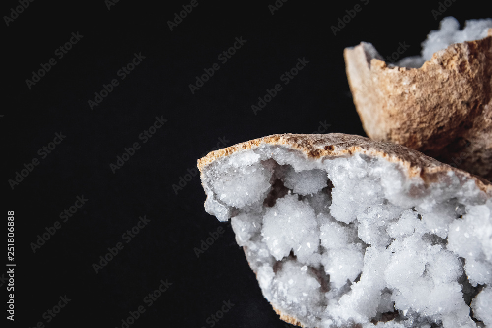 Agate. A cross section of agate stone with geode on a black background. Origin: Morocco, Sidi Rachal Agate. A cross section of agate stone with geode on a black background. Origin: Morocco, Sidi Rachal
