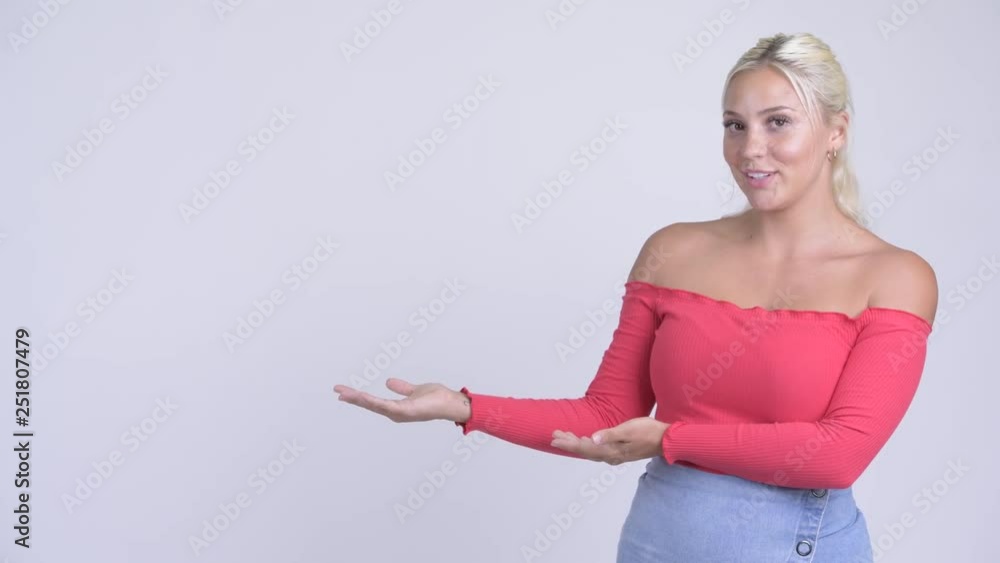 Happy young beautiful blonde woman showing something Happy young beautiful blonde woman showing something