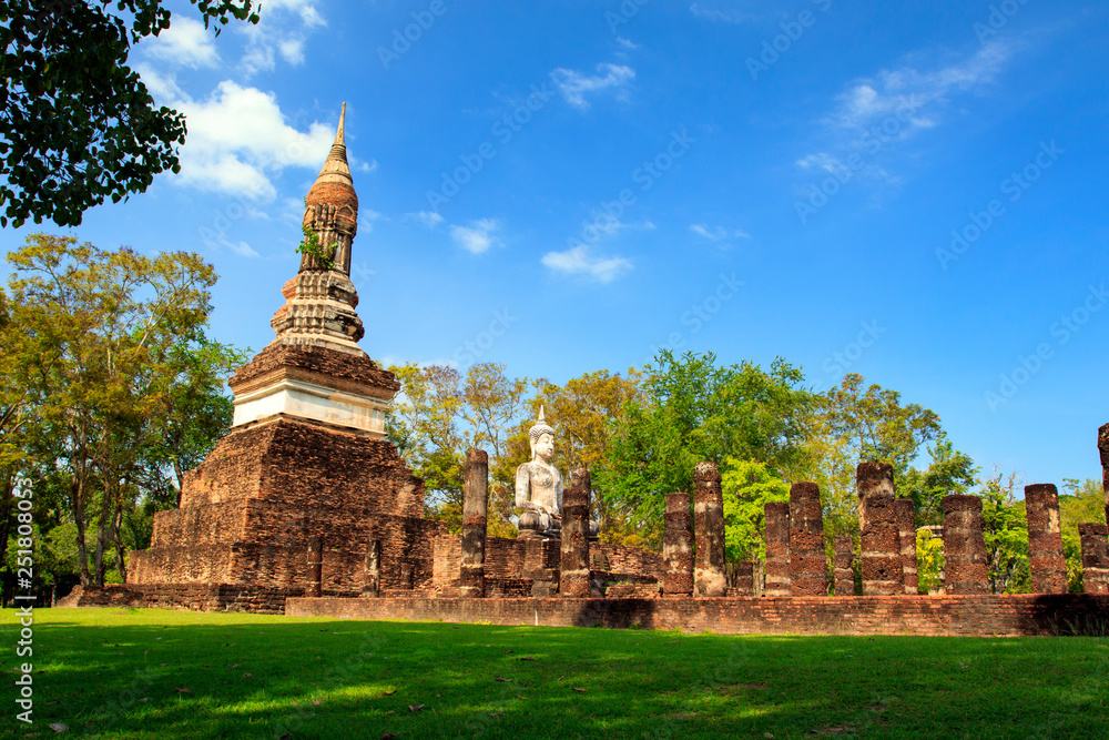 Fototapeta premium Pagoda and the buddha statue. in Old Buddhist temple in Sukhothai historical park In Thailand., Tourism, World Heritage Site, Civilization,UNESCO.