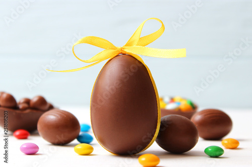 Canvas-taulu Easter composition with chocolate eggs and chocolate rabbit on wooden backgroun