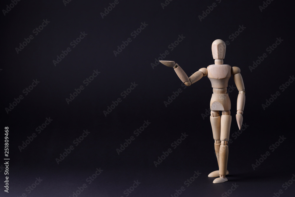 Wooden mannequin on a black background Wooden mannequin on a black background