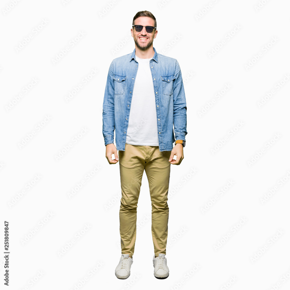 Handsome man wearing fashion sunglasses with a happy and cool smile on face. Lucky person. Handsome man wearing fashion sunglasses with a happy and cool smile on face. Lucky person.