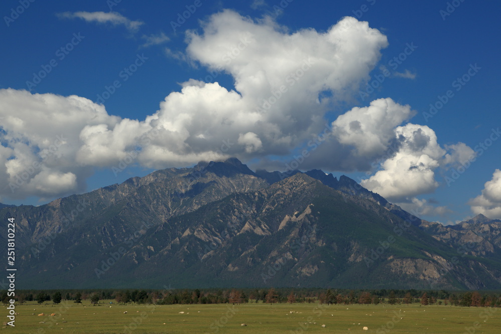 The mountains of the Barguzin mountains, this valley of the Barguzin river Steppe in the floodplain of the Barguzin river, then-birch forest belt, and behind it-the mountains of Barguzin ridge and the