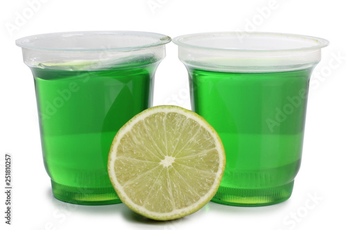 Jam in cup with lemon lemon on white background
