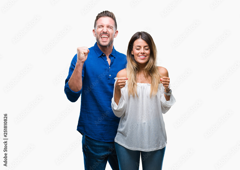 Young couple in love over isolated background excited for success with arms raised celebrating victory smiling. Winner concept. Young couple in love over isolated background excited for success with arms raised celebrating victory smiling. Winner concept.
