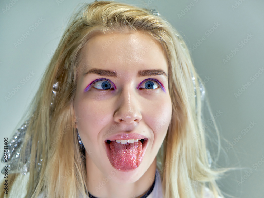 Concept work of a beautician cosmetologist in with office. Makes hair, applies makeup on a gray background. Concept work of a beautician cosmetologist in with office. Makes hair, applies makeup on a gray background.
