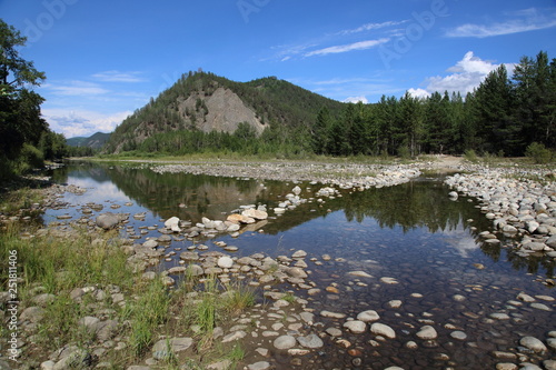 Siberian river Barguzin in the upper summer day in one of its turns between the slopes of the mountains