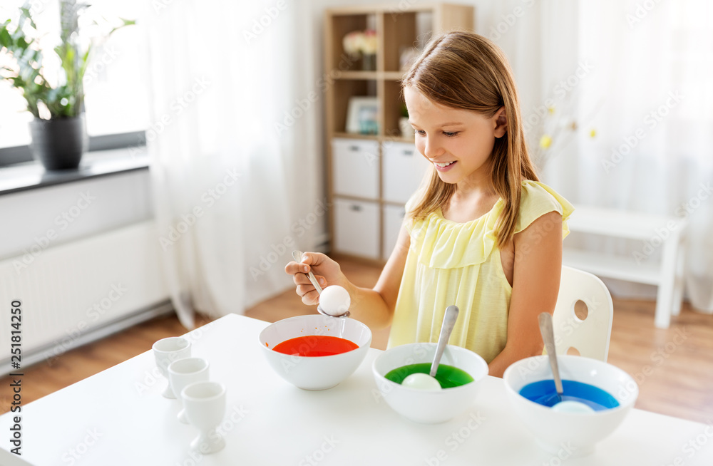easter, holidays and people concept - happy girl coloring eggs by liquid dye at home easter, holidays and people concept - happy girl coloring eggs by liquid dye at home
