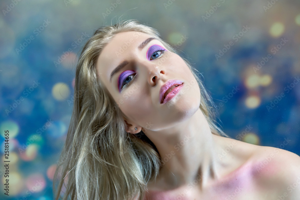Close-up portrait concept of a beautiful blonde girl on a multi-colored background. Hair develops in different directions. Close-up portrait concept of a beautiful blonde girl on a multi-colored background. Hair develops in different directions.