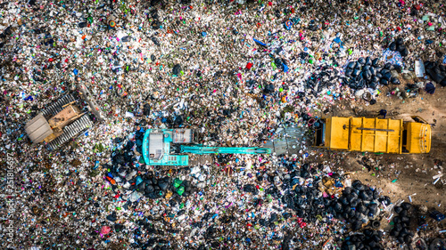 Garbage pile  in trash dump or landfill abundance, Aerial view garbage truck unload garbage to a landfill,  Biohazard global warming ecosystem and healthy environment concept. photo