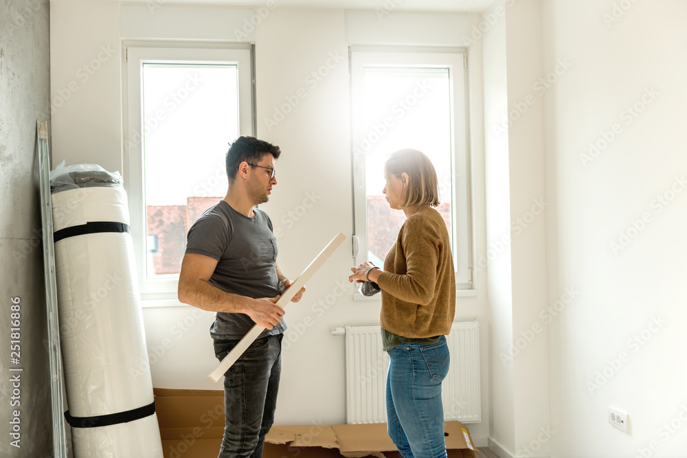 Couple assembling furniture in their new house Couple assembling furniture in their new house