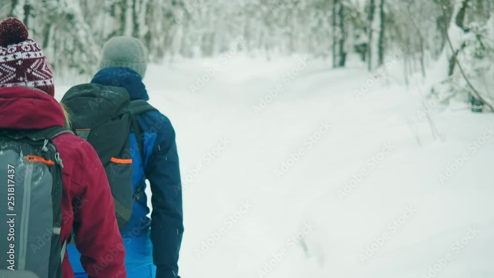 Couple travelers man and woman walking snow forest in winter. Love and travel happy emotions lifestyle concept. Young family traveling active adventure vacations. Healthy active lifestyle young people Couple travelers man and woman walking snow forest in winter. Love and travel happy emotions lifestyle concept. Young family traveling active adventure vacations. Healthy active lifestyle young people