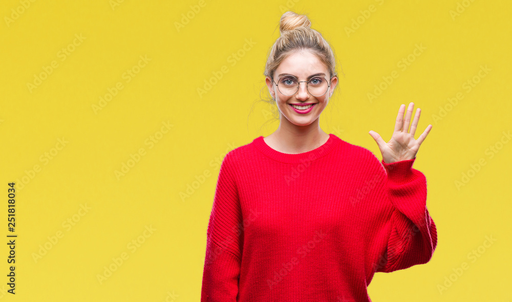Young beautiful blonde woman wearing red sweater and glasses over isolated background showing and pointing up with fingers number five while smiling confident and happy. Young beautiful blonde woman wearing red sweater and glasses over isolated background showing and pointing up with fingers number five while smiling confident and happy.