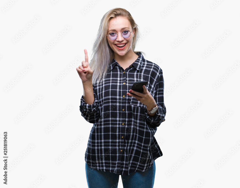Young blonde woman texting sending message using smartphone over isolated background surprised with an idea or question pointing finger with happy face, number one Young blonde woman texting sending message using smartphone over isolated background surprised with an idea or question pointing finger with happy face, number one