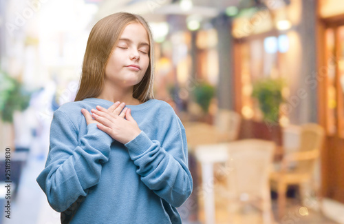 Wallpaper Mural Young beautiful girl wearing winter sweater over isolated background smiling with hands on chest with closed eyes and grateful gesture on face. Health concept. Torontodigital.ca